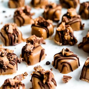 peanut butter fudge topped with chocolate and crushed peanut butter cups.