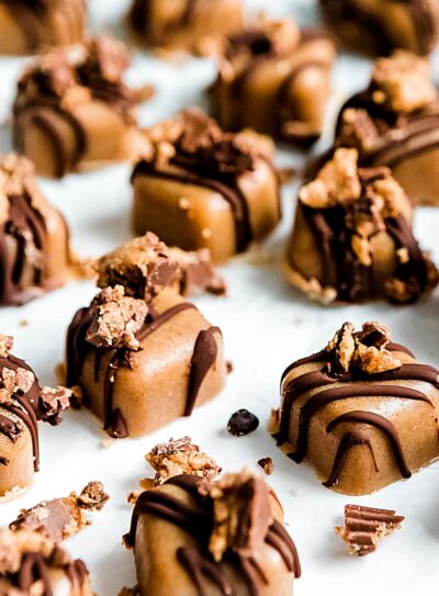 peanut butter fudge topped with chocolate and crushed peanut butter cups.