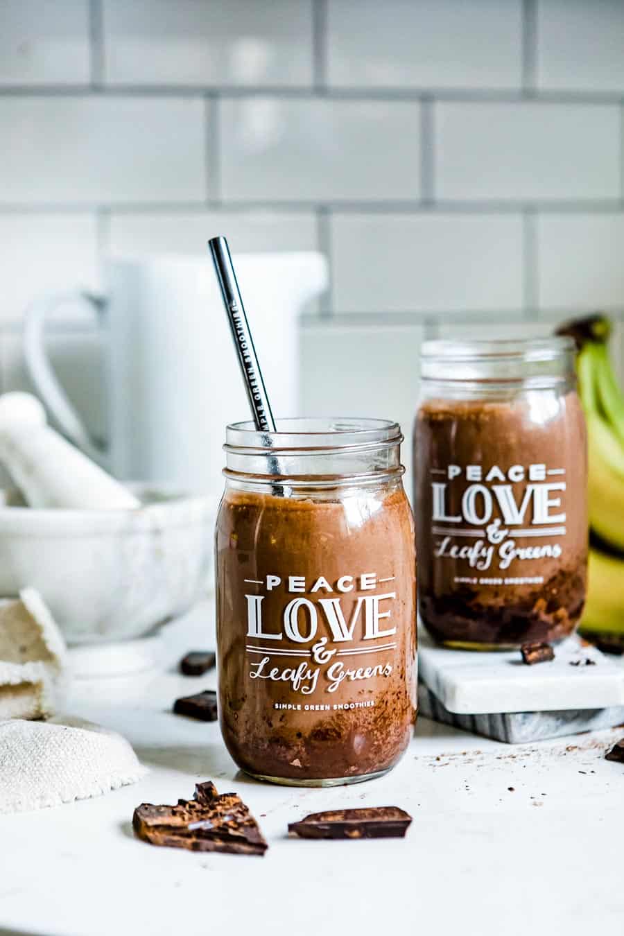 2 jars of chocolate smoothie with black straw.