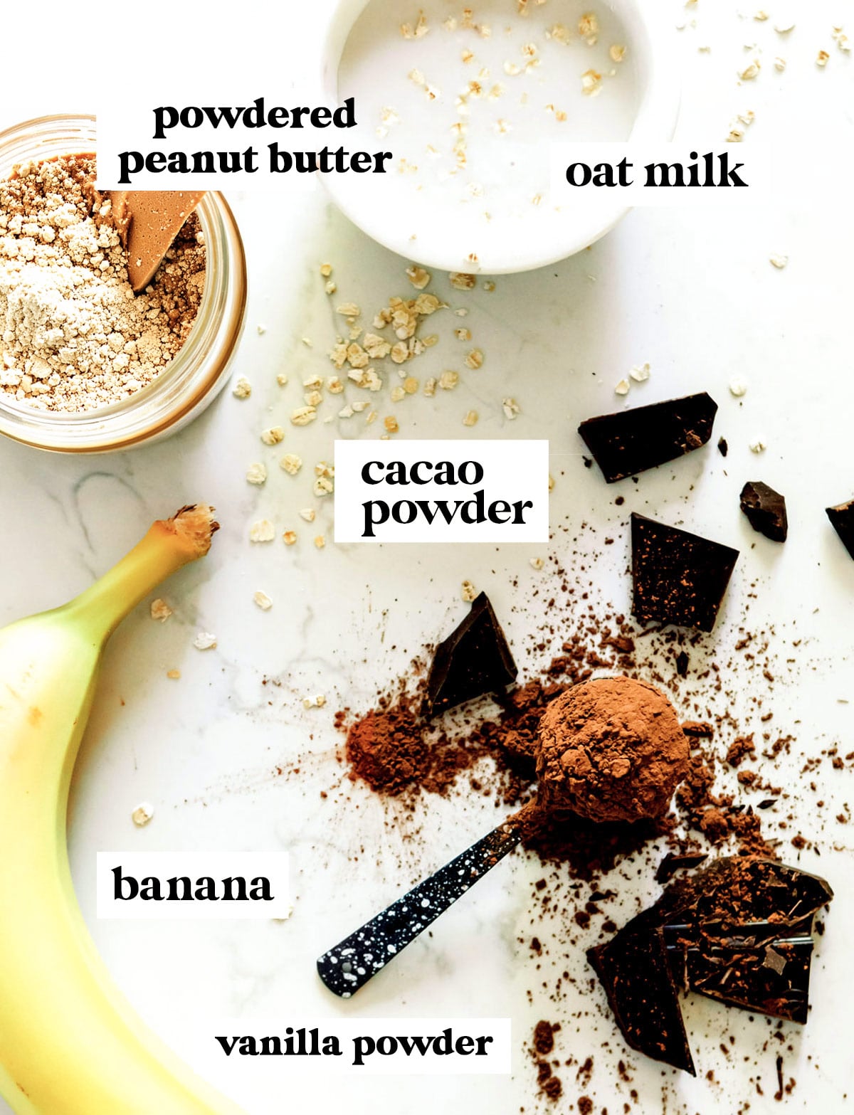 Ingredients for a chocolate peanut butter smoothie laid out on a counter.