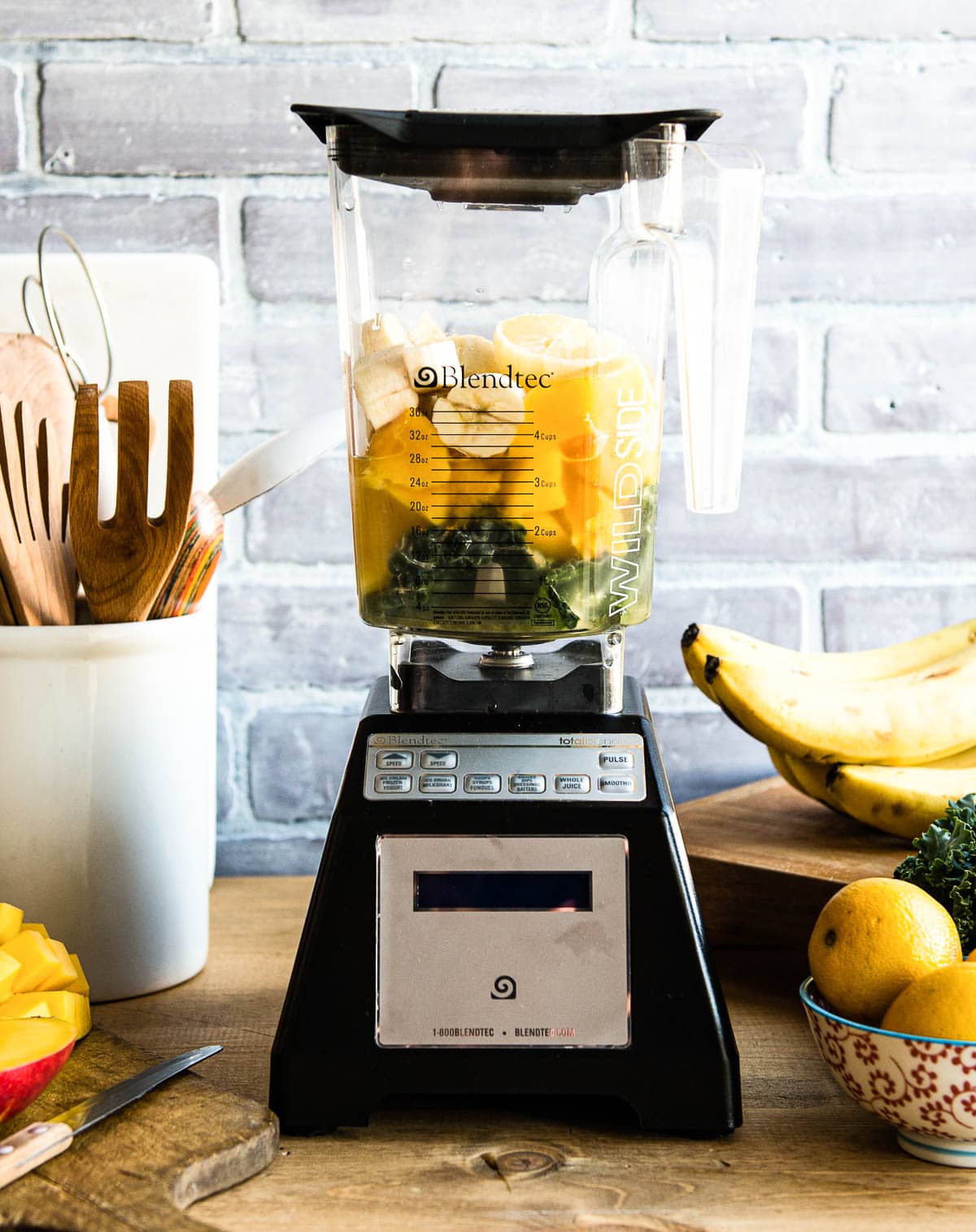 blender full of ingredients for a tropical smoothie, not yet blended.