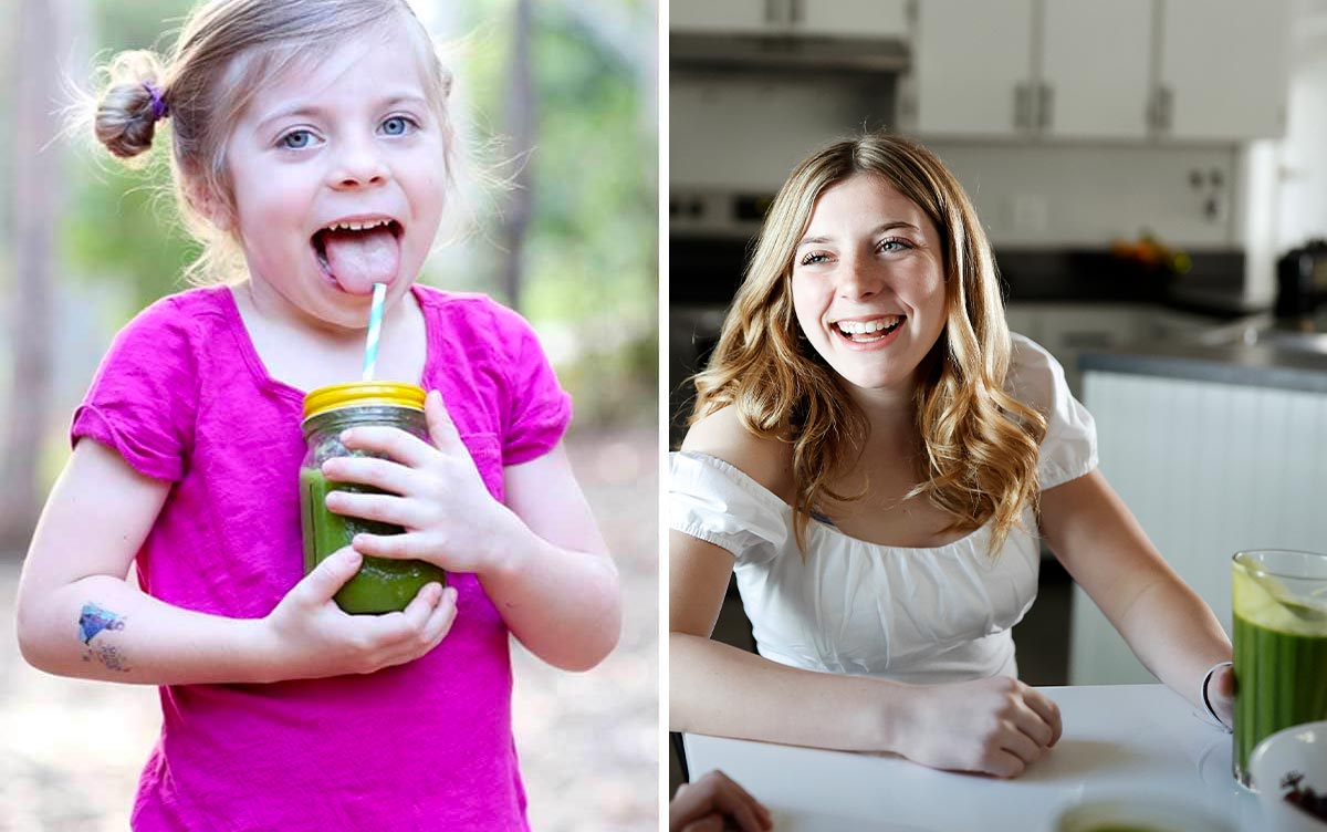 Girl drinking green smoothies in mason jar with metal straw and smiling.