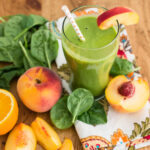 coconut milk smoothie with fresh fruit and leafy greens