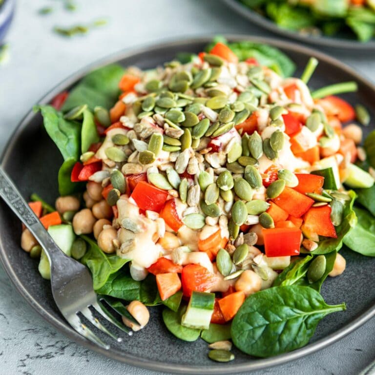 chickpea salad on a gray plate with a stainless steel fork.