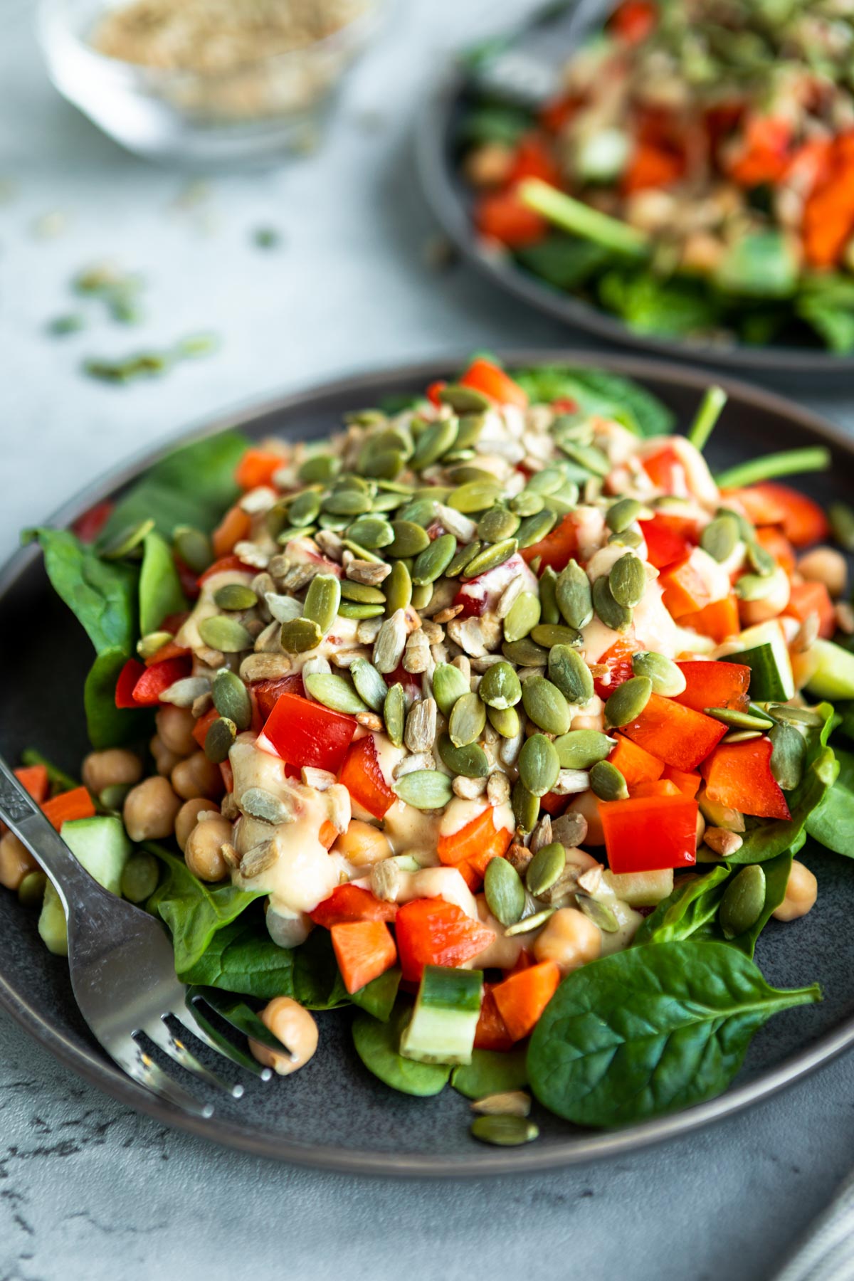 crunchy chickpea salad with spinach, chickpeas, pepitas and vegetables.