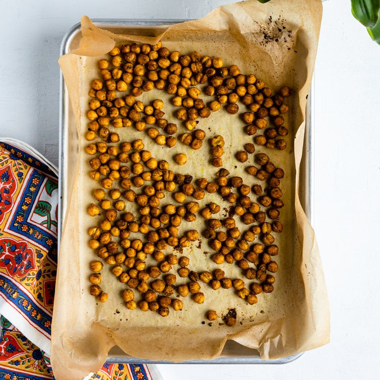 A baking dish full of oven-baked garbanzo beans.