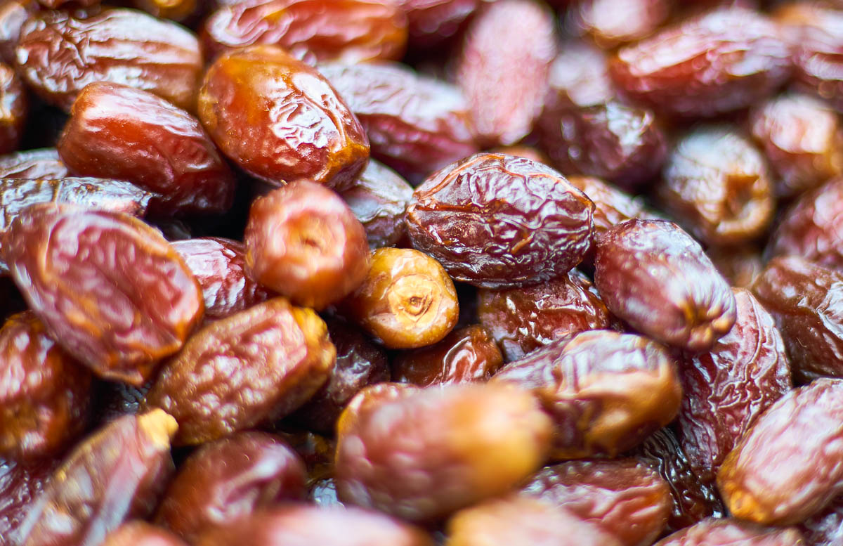 Fresh Medjool dates with wrinkled skin and a glossy finish
