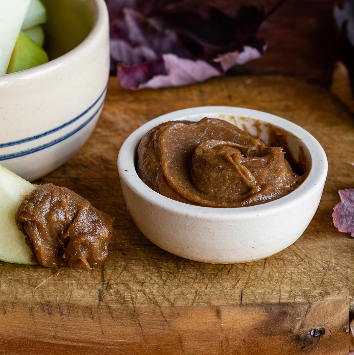 Bowl of homemade date caramel with apple slices