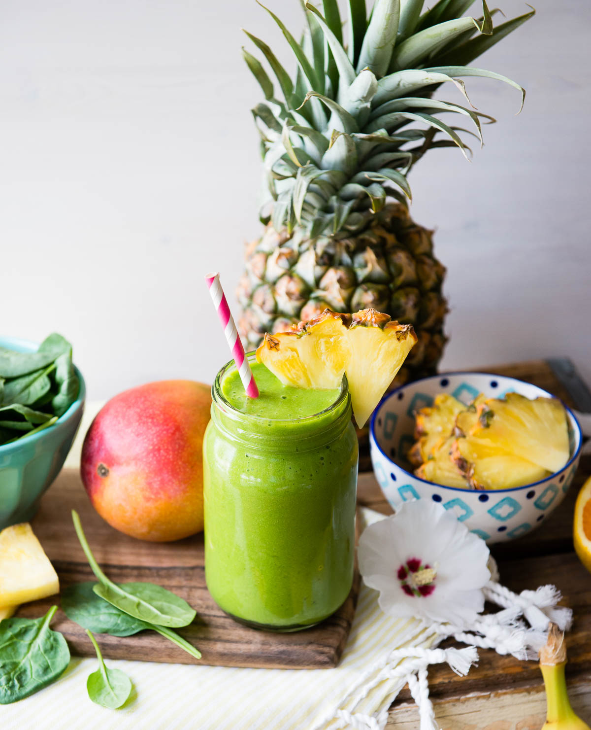 A refreshing detox island green smoothie topped with pineapple.