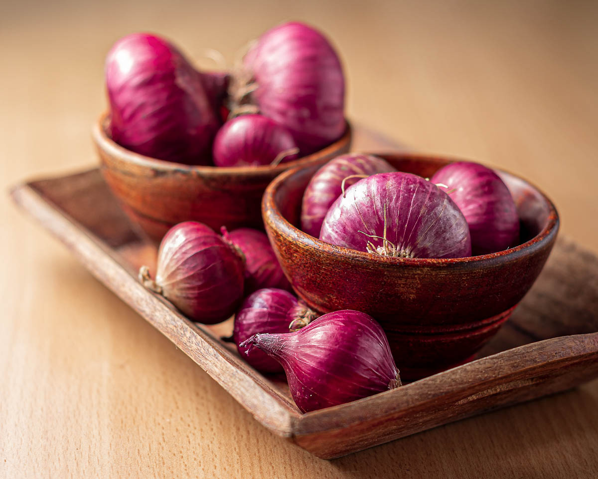 2 wooden bowls of purple onions, listed on EWG's Clean 15 List.