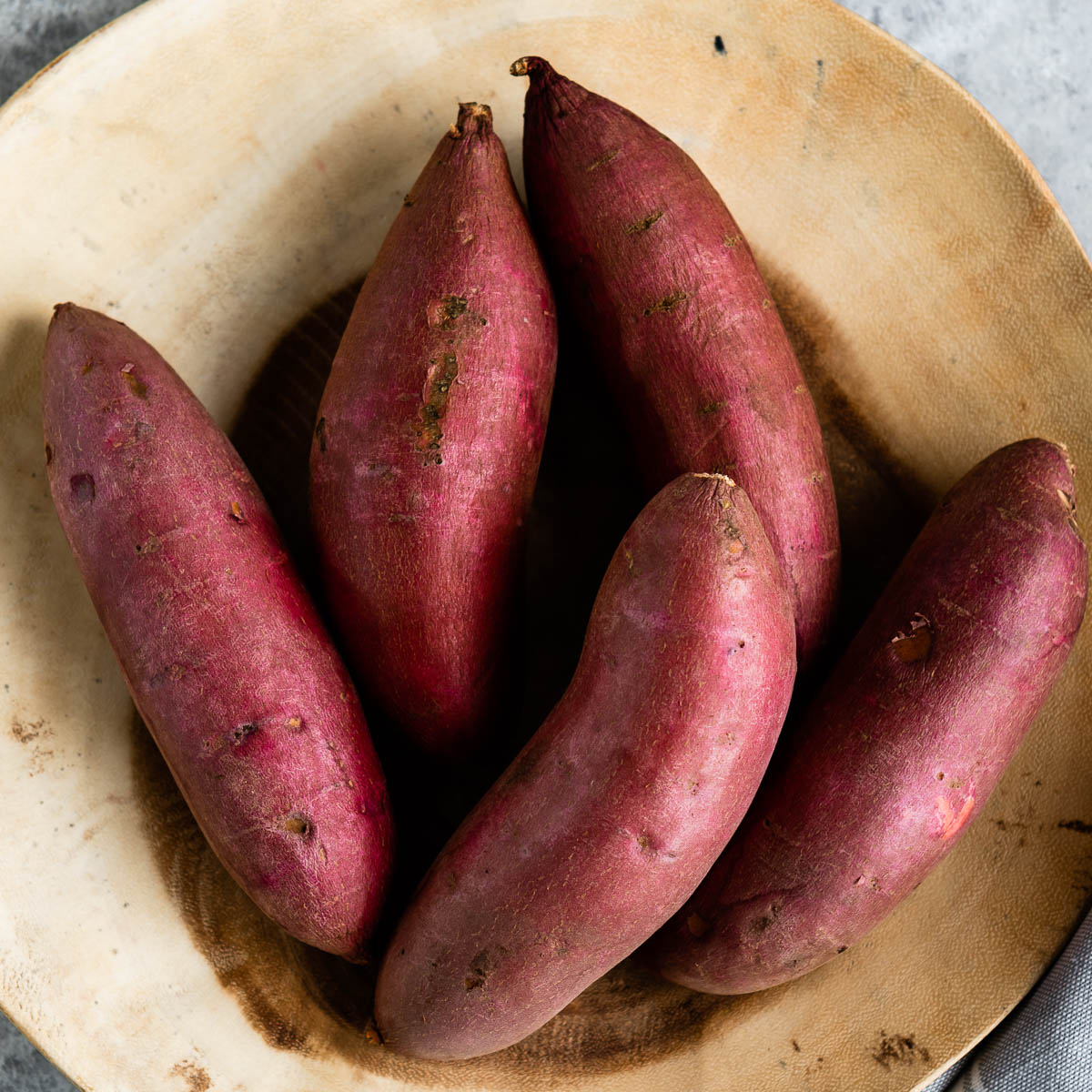 large wooden bowl of sweet potatoes.