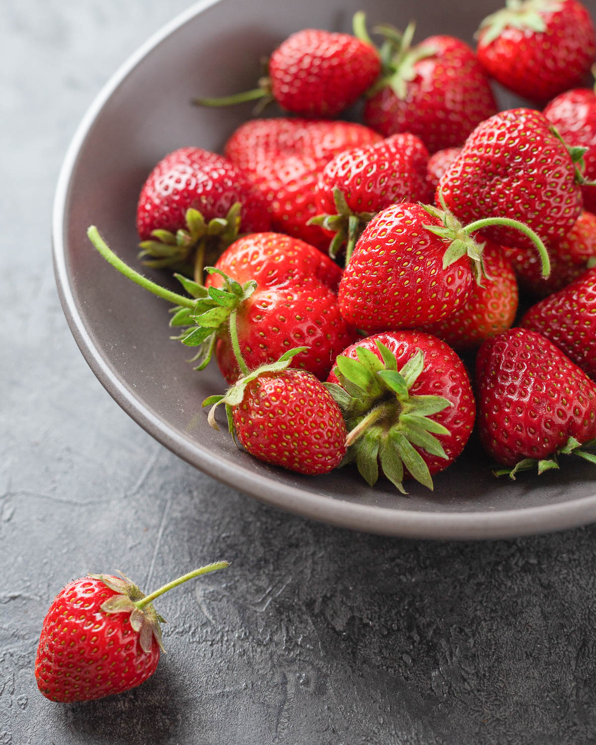 gray bowl of fresh strawberries.