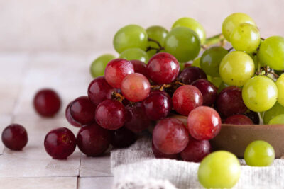 red and green grapes on counter after being washed