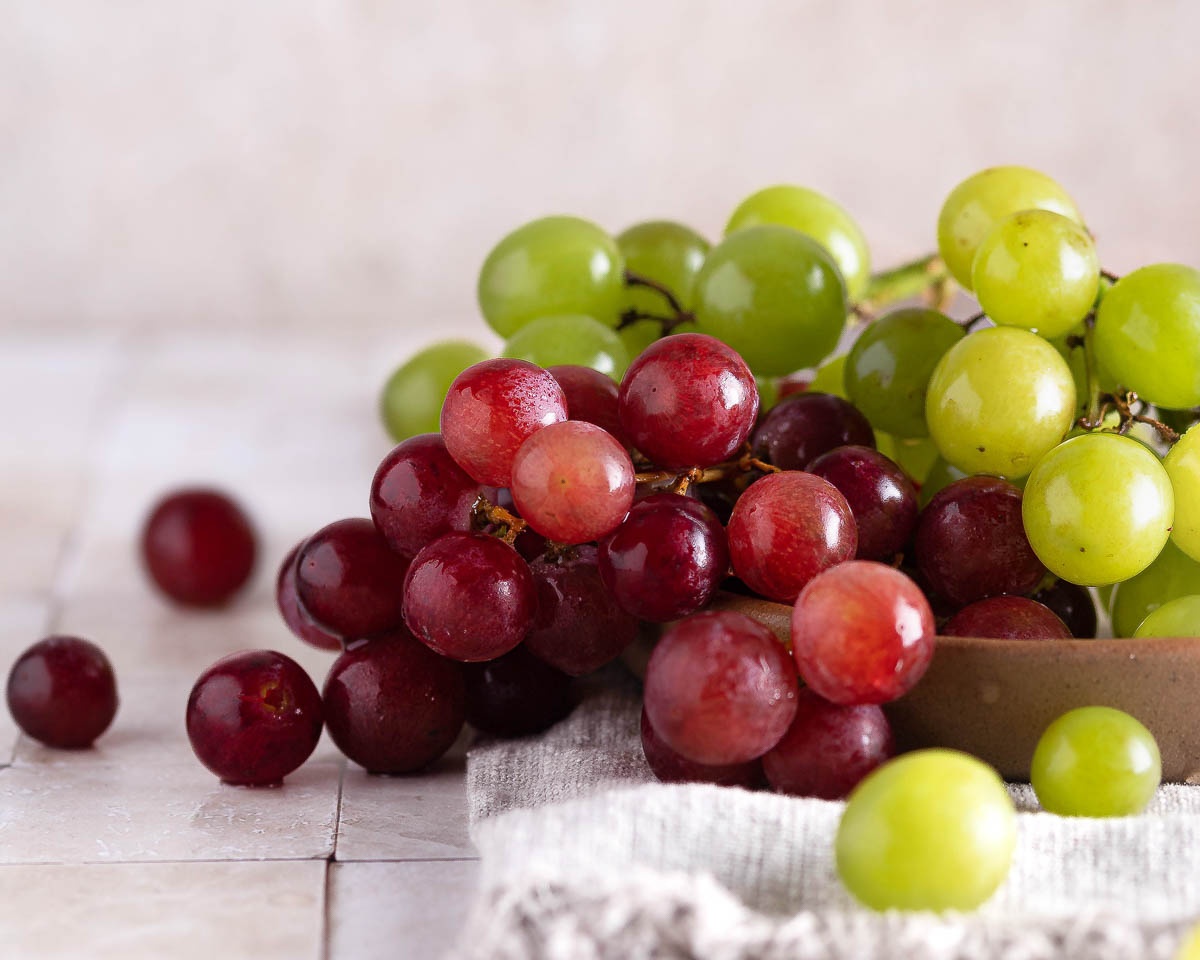 bowl of green and red grapes.