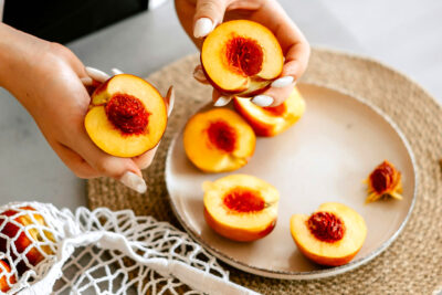 Fresh nectarines cut on counter with plate