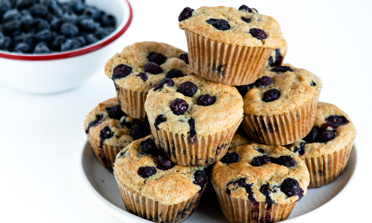 plate of stacked blueberry muffins as an easy summer snack idea.