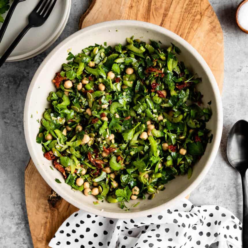 marinated celery salad in a bowl on a wooden plank as an easy summer meal idea.