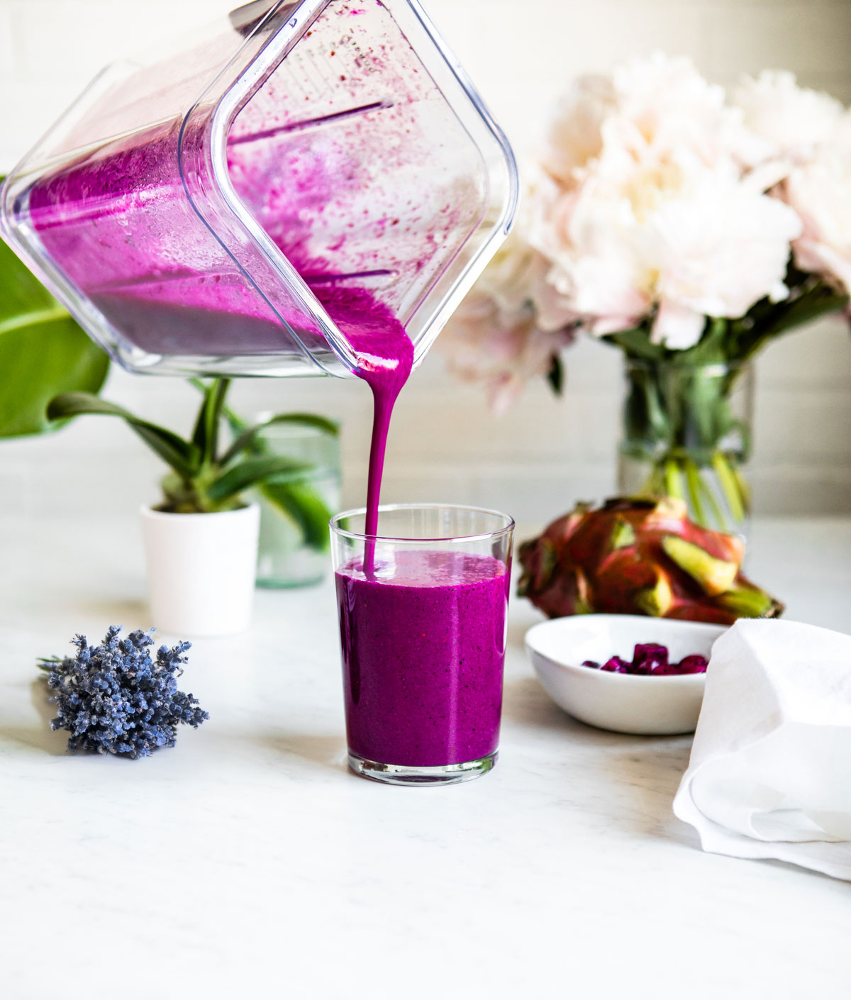 Elderberry smoothie getting poured into a glass.