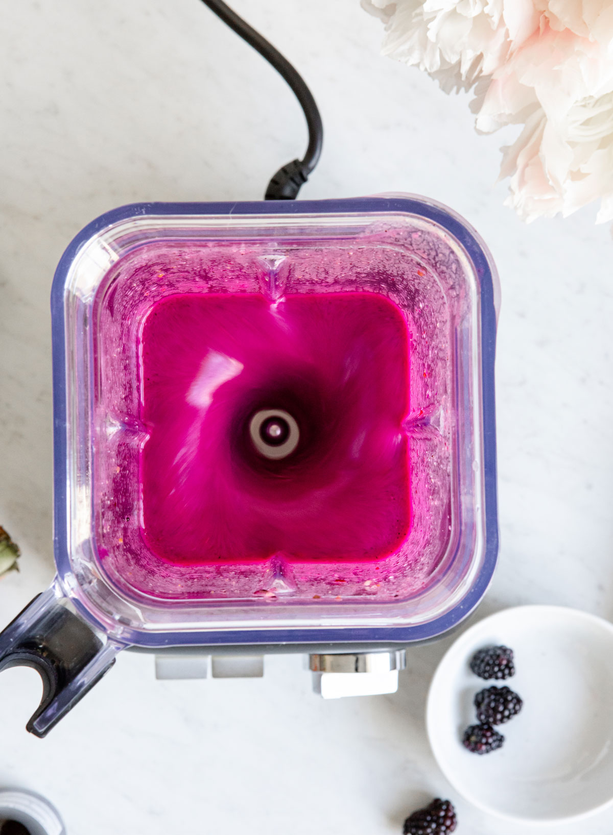 Blending elderberry smoothie in a high speed blender.