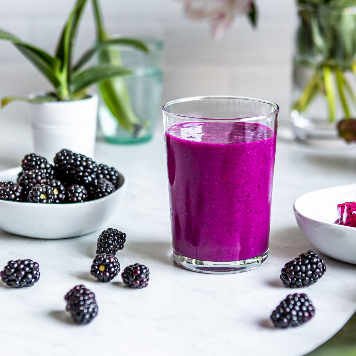 Elderberry smoothie recipe getting poured into a clear glass.