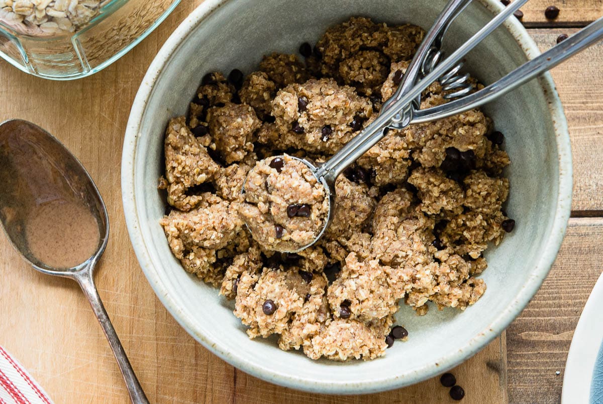 bowl of cookie dough that doesn't need baked, with a cookie scoop.