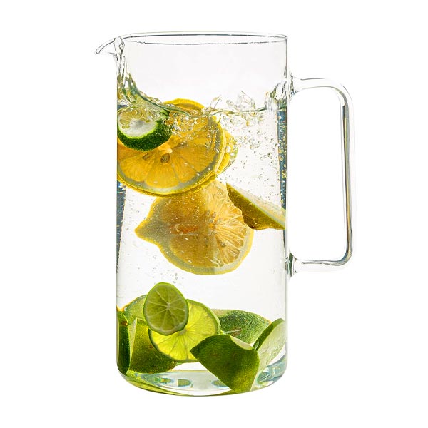 glass pitcher with lemons and limes