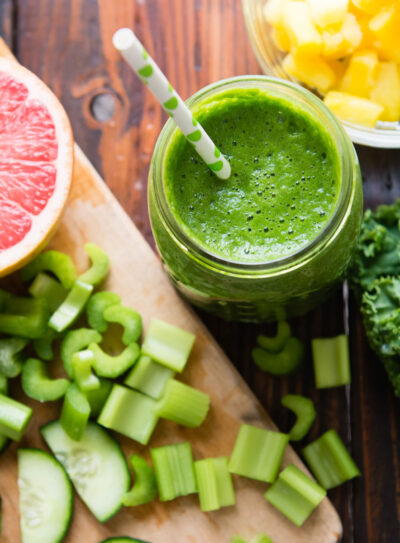 Fat-burning smoothie for weight loss on table with half a grapefruit.