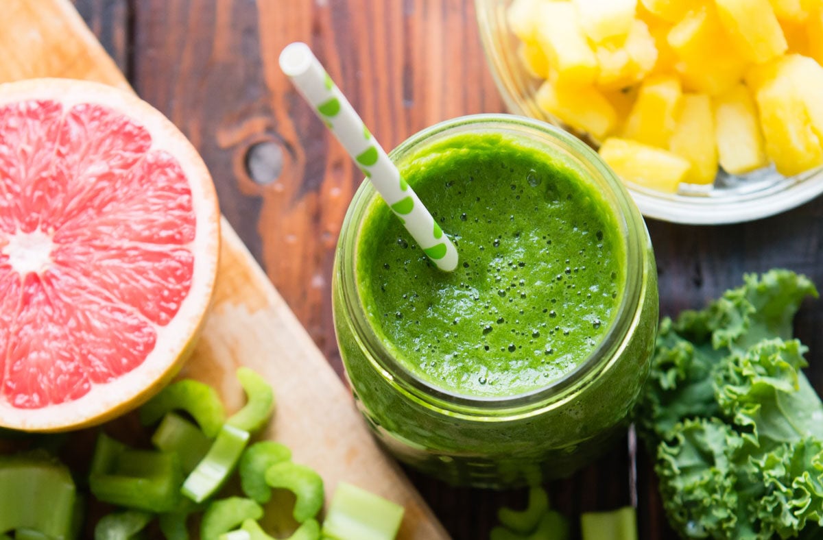 Fat-burning smoothie for weight loss on table with half a grapefruit.