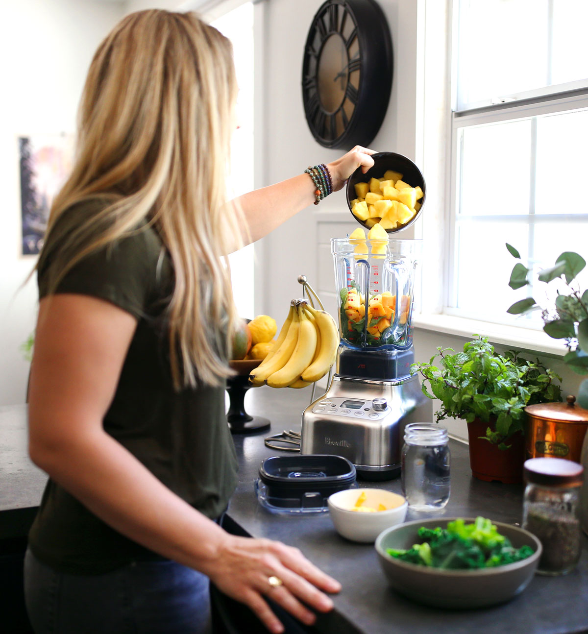 Jen Hansard blending weight loss smoothies in her kitchen on concrete countertop.