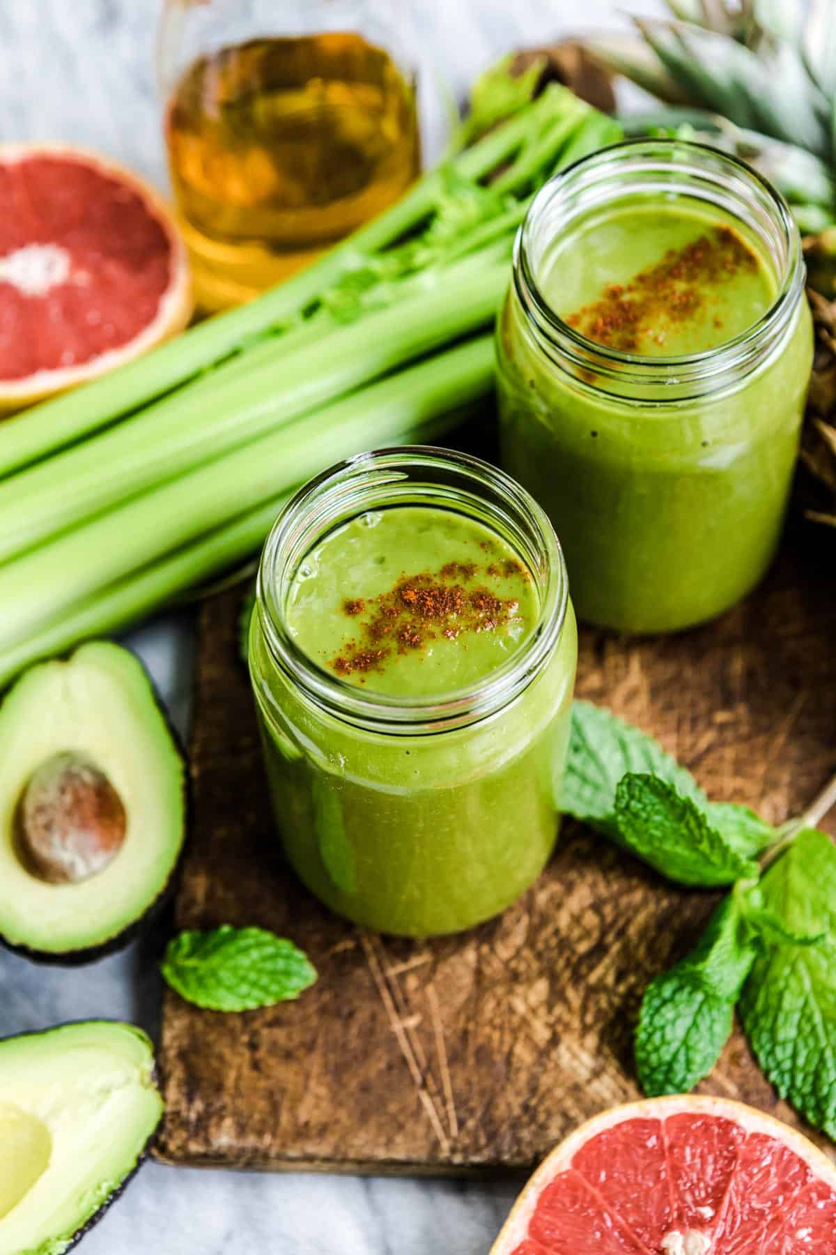 fat burning smoothies in mason jars with fresh ingredients.