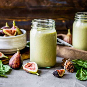 Fig smoothie recipe on table with fresh figs.