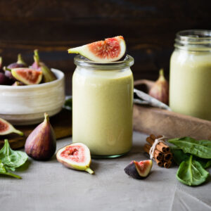 Fig smoothie recipe on table with fresh figs.