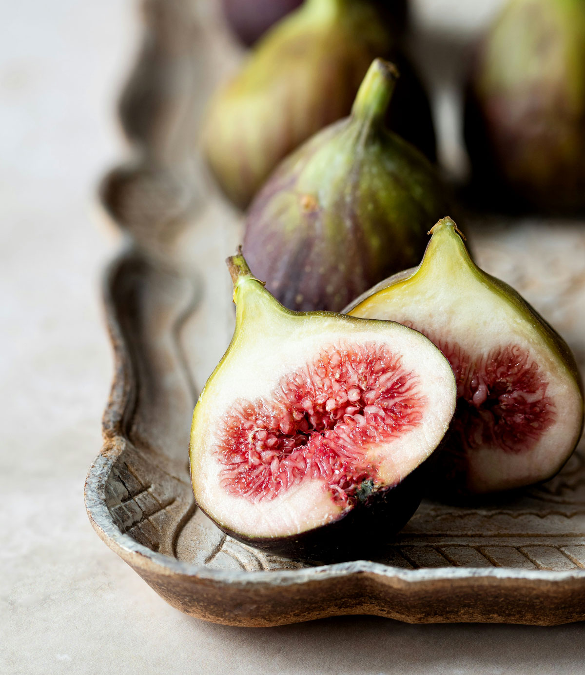 Fresh figs on wood plate sliced.