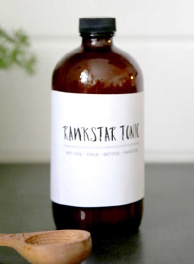 dark glass bottle with white label that says Rawkstar Tonic, a fire cider recipe
