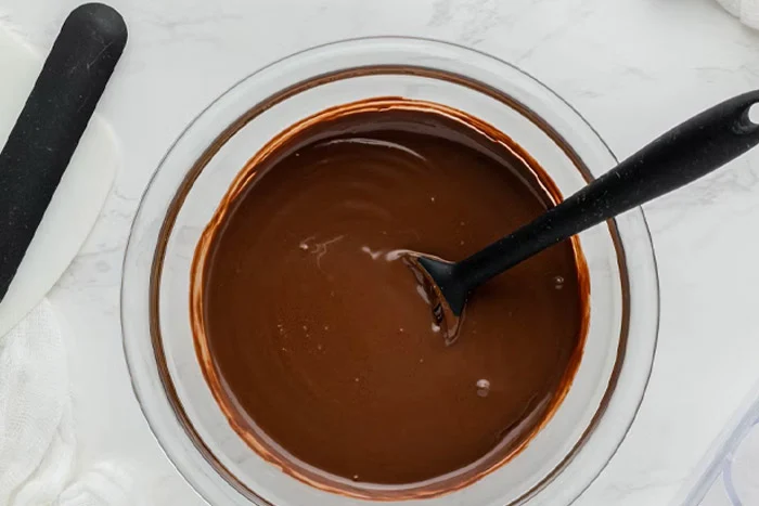 melt coconut oil + chocolate chips in a small saucepan