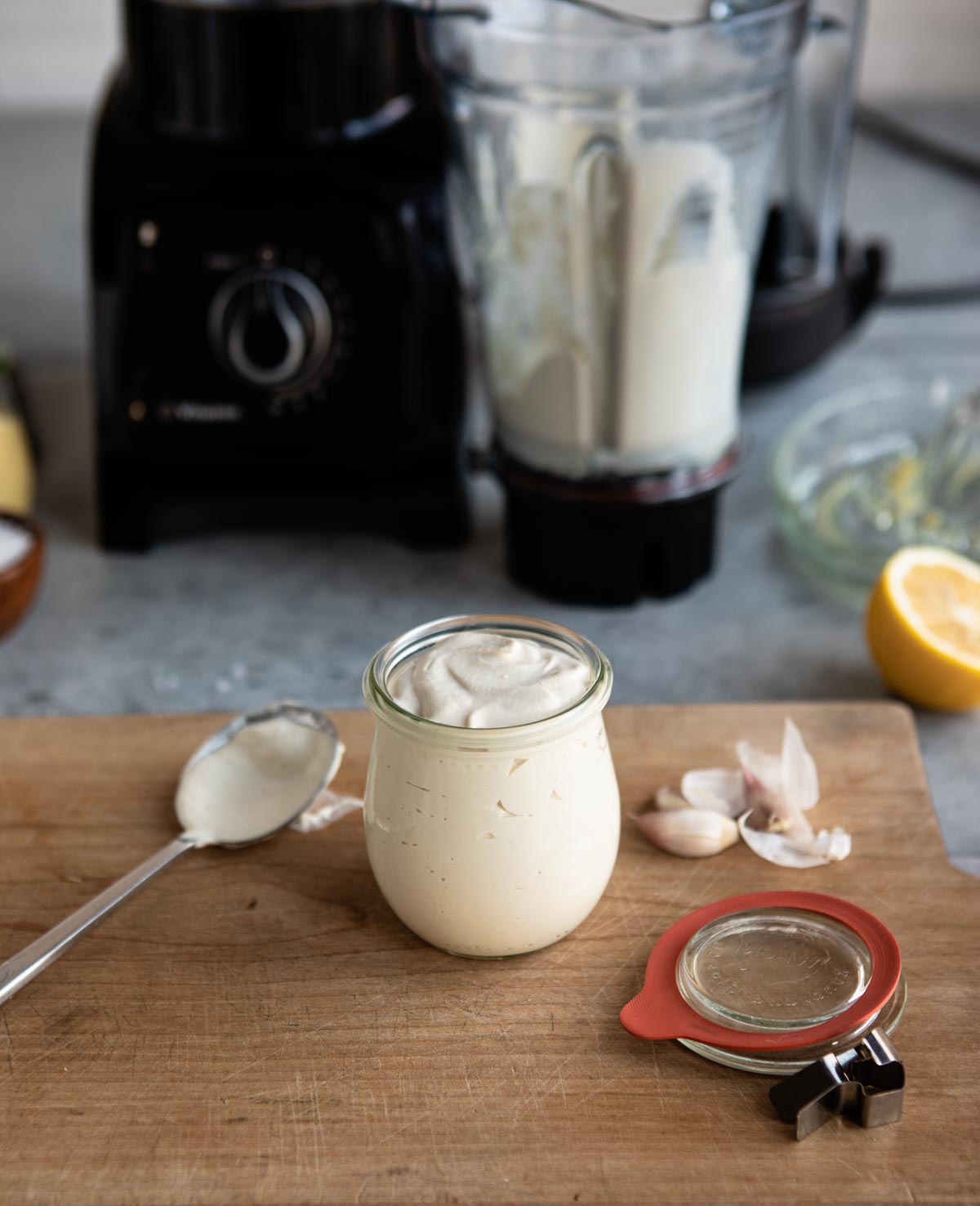 easy homemade dressing in glass jar with rub sealed lid on wooden cutting board.