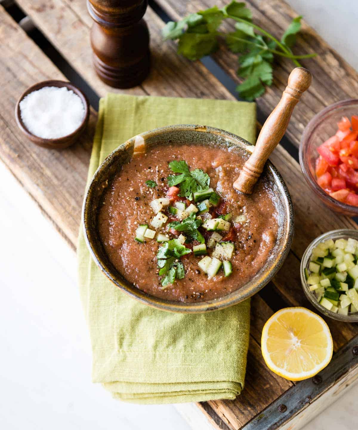 Fresh and bright bowl of gazpacho soup recipe in brown ceramic bowl