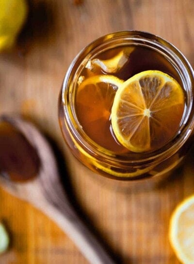 All natural ginger honey lemon tea cough remedy in a glass jar.