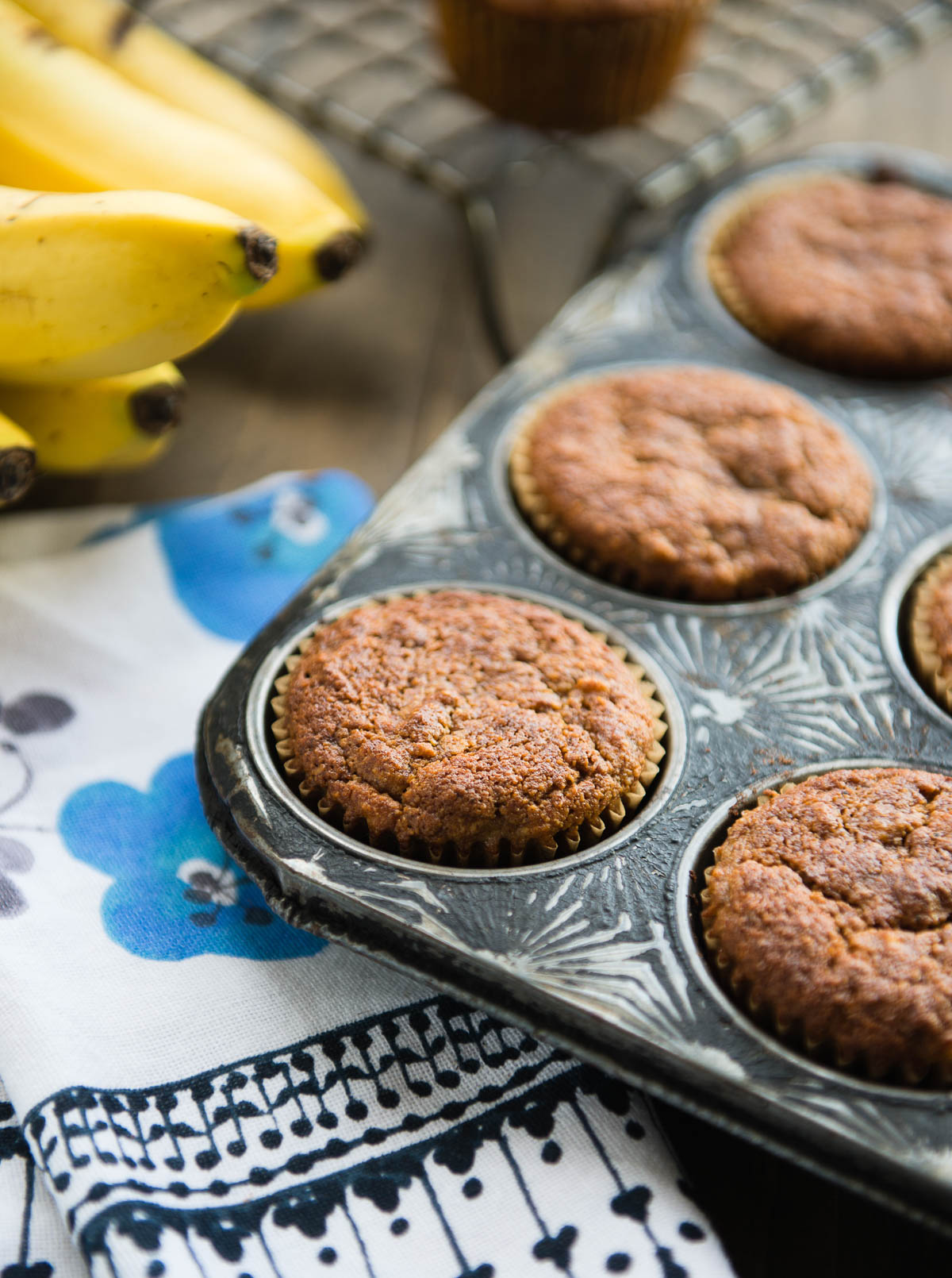 antique muffin pan with baked almond flour banana muffins.