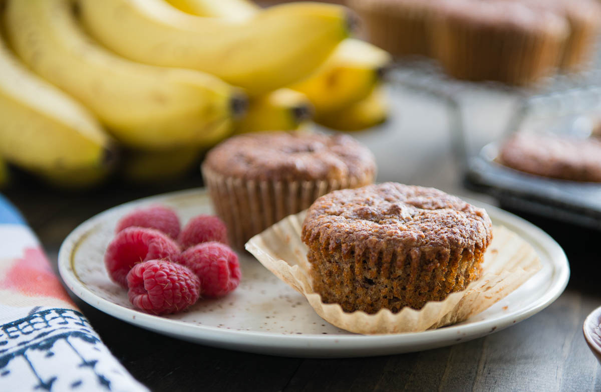 almond flour muffins on a plate with fresh raspberries,