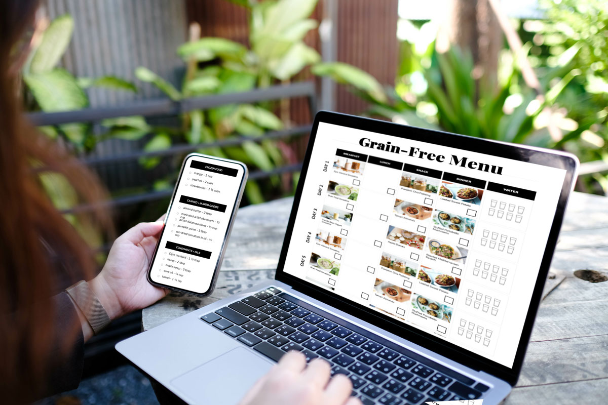 computer and smart phone open to a screen that says Grain Free Menu with photos of recipes.