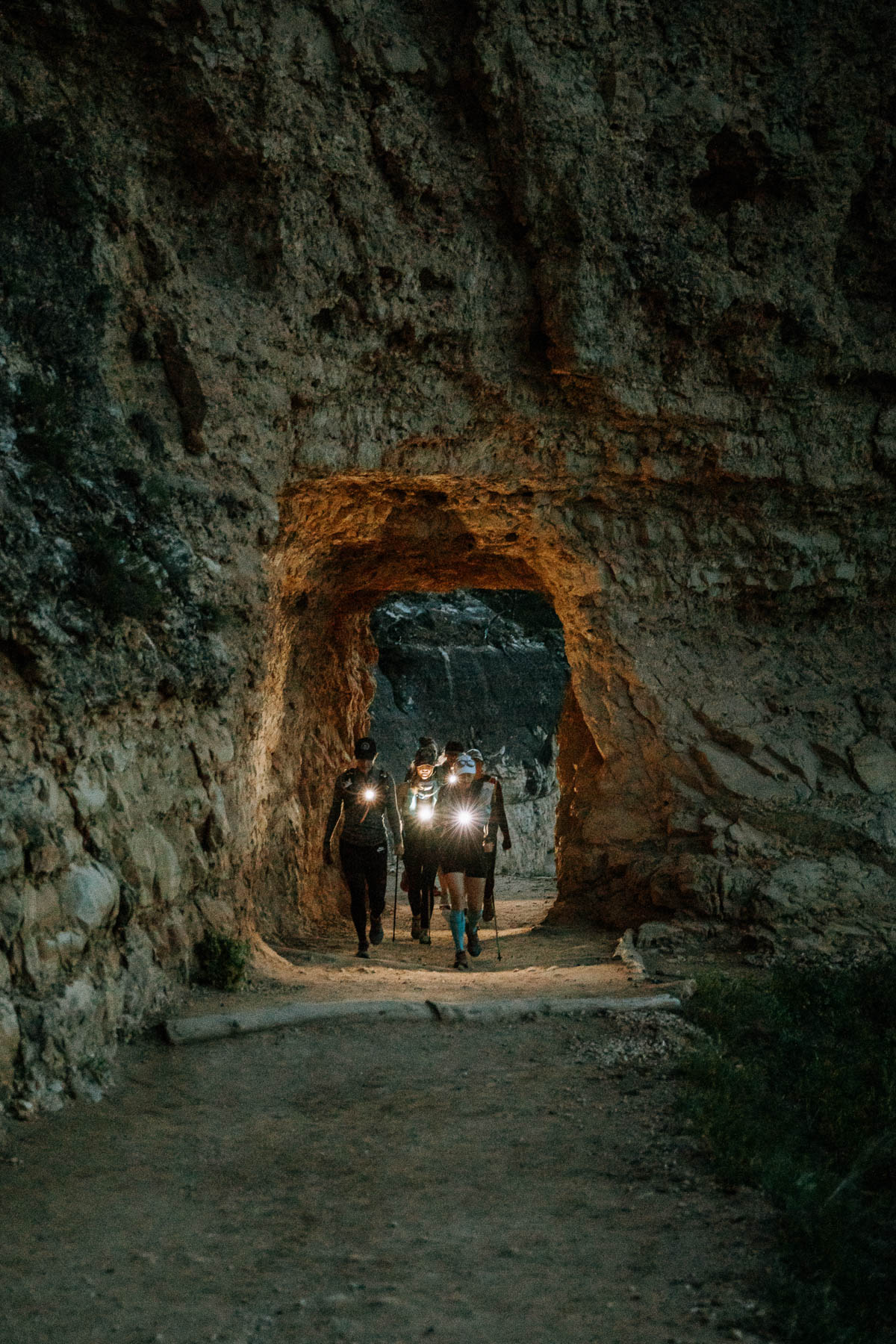 Tunnel at end of Grand Canyon Rim to Rim one day hike with women in headlamps.