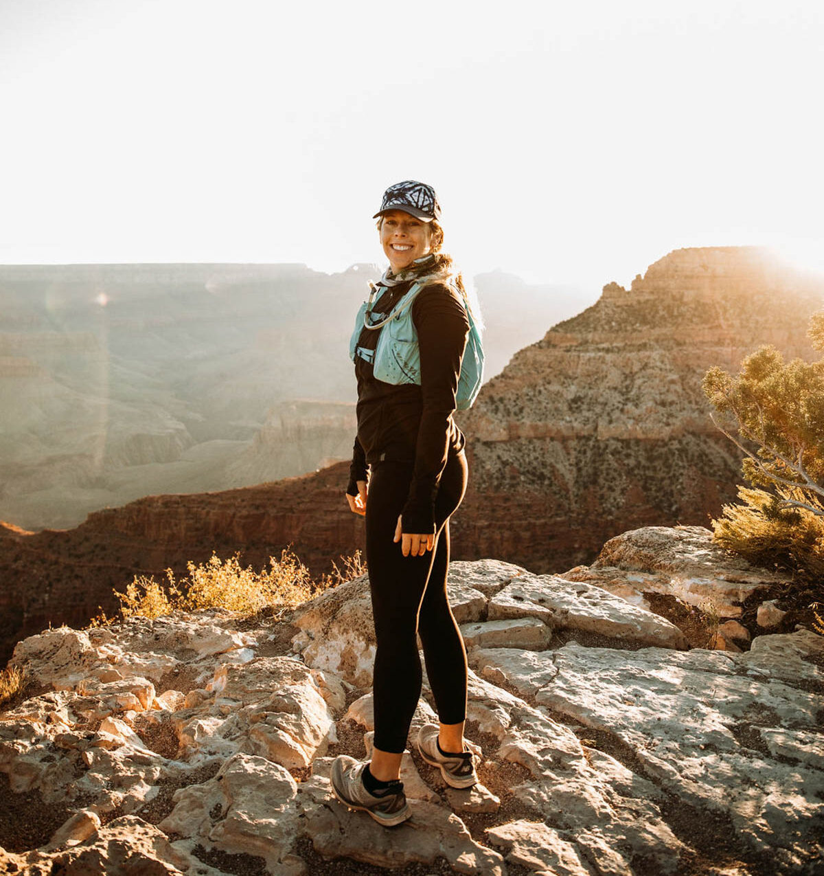Woman in grand canyon getting ready to hike with hat.