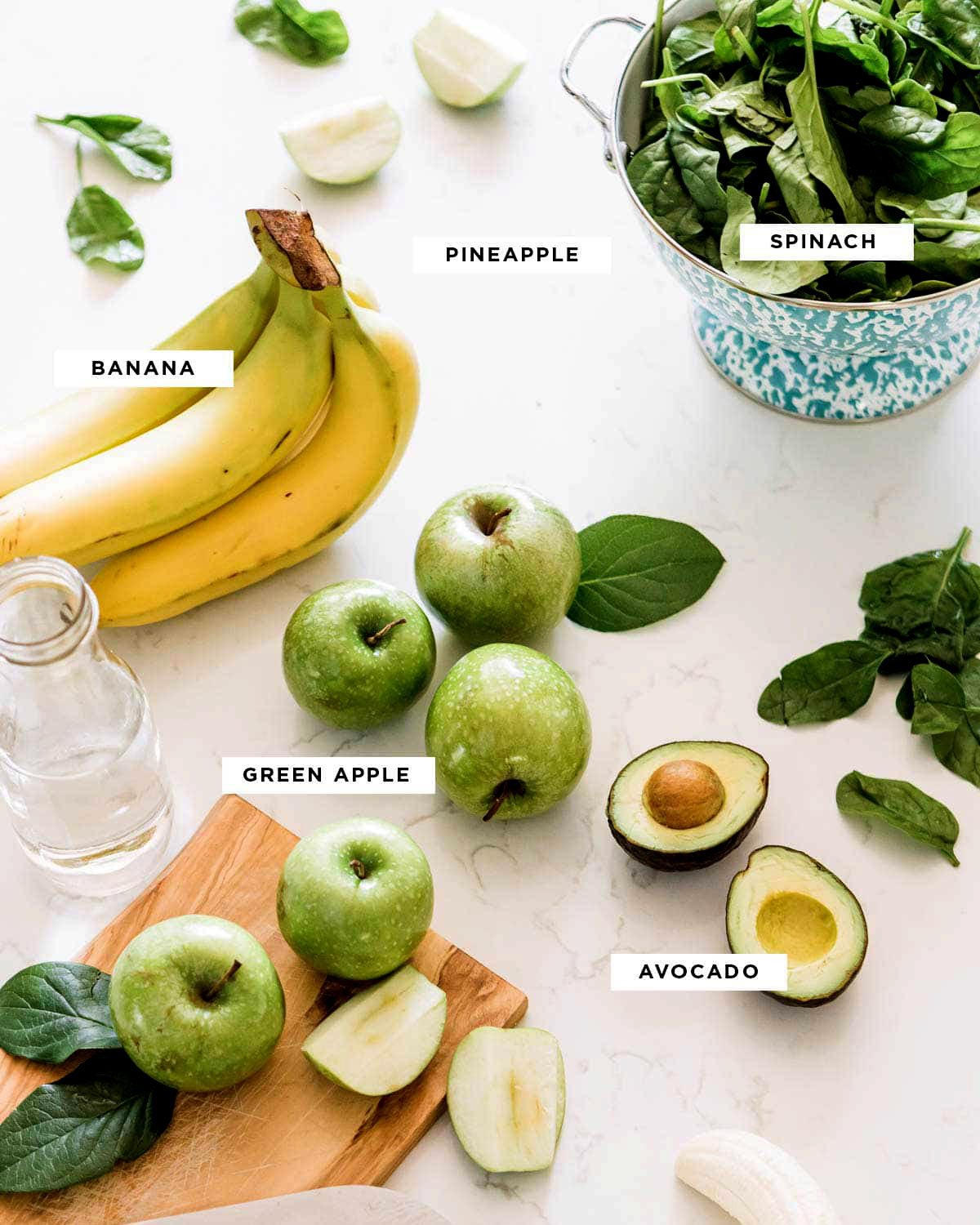 Ingredients for a green apple smoothie recipe, including spinach, banana, pineapple, avocado, and green apple, prepared for an easy and healthy smoothie.