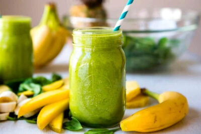 Green smoothie on counter for weight loss support.