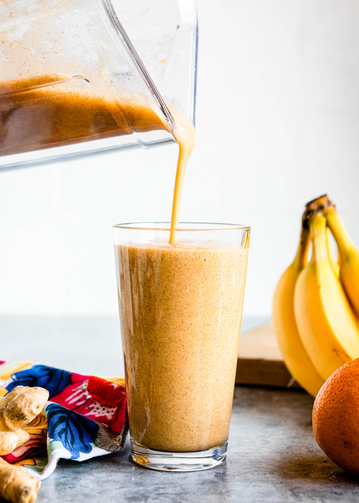 pouring hangover cure drink from a blender container into a tall glass.