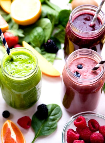 A top-down view of a wooden cutting board with two mason jars breakfast smoothies for weight loss.