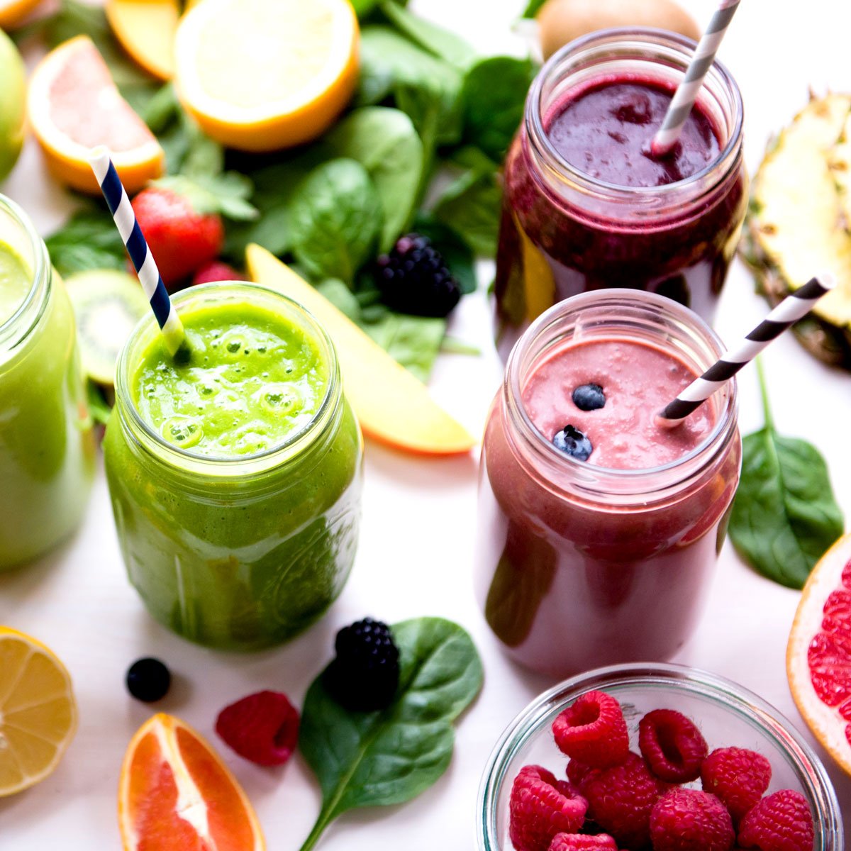 A top-down view of a wooden cutting board with two mason jars breakfast smoothies for weight loss.