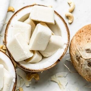 Frozen smoothie cubes in a halved coconut.