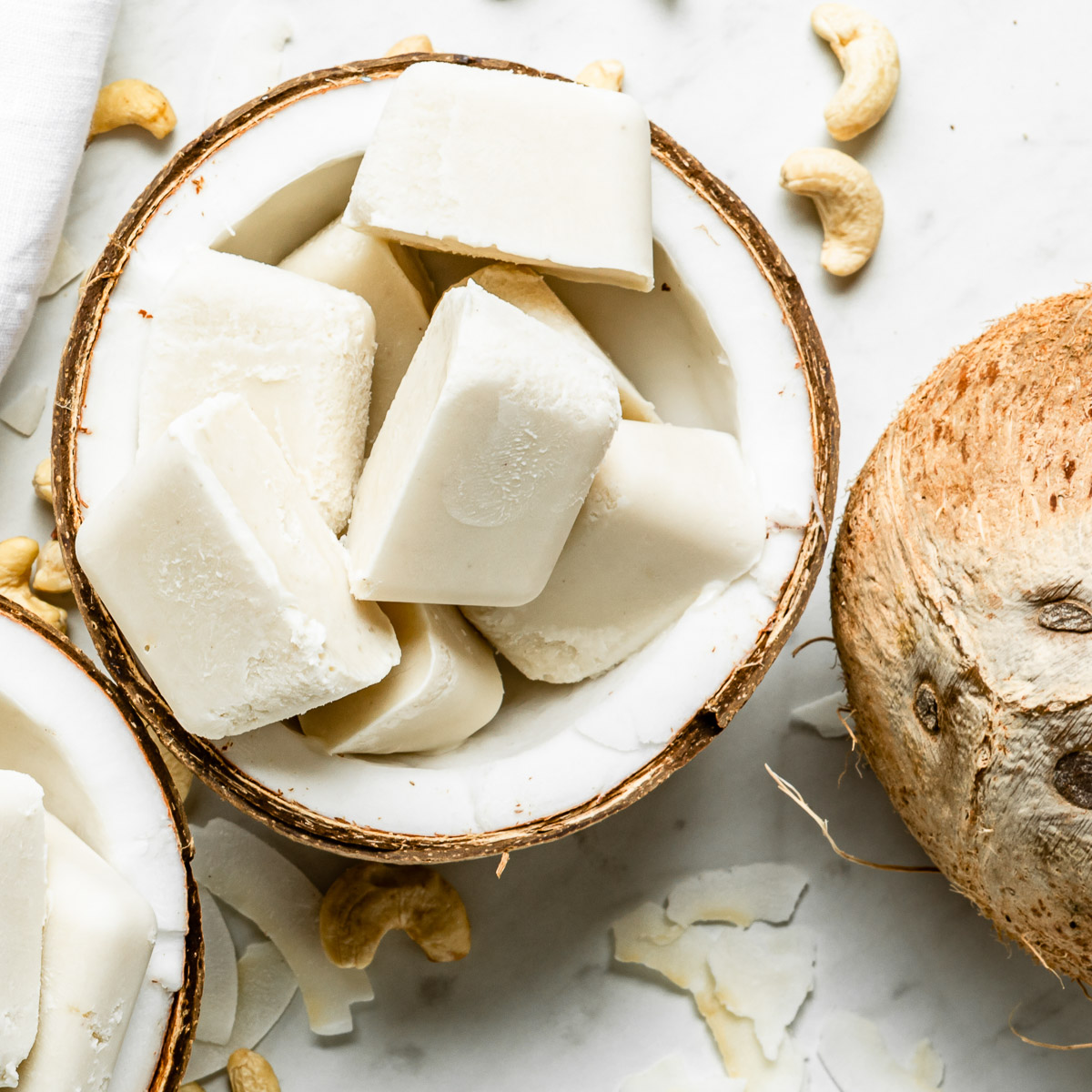 Frozen smoothie cubes in a halved coconut.
